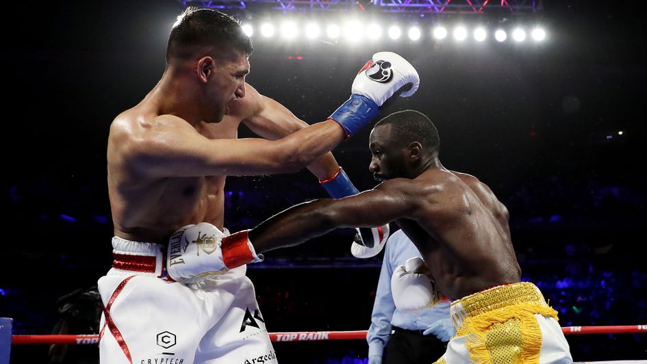Terence Crawford punches Amir Khan during their WBO welterweight title fight