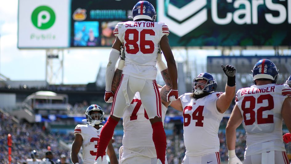 Jon Feliciano holds up Darius Slayton to celebrate a touchdown