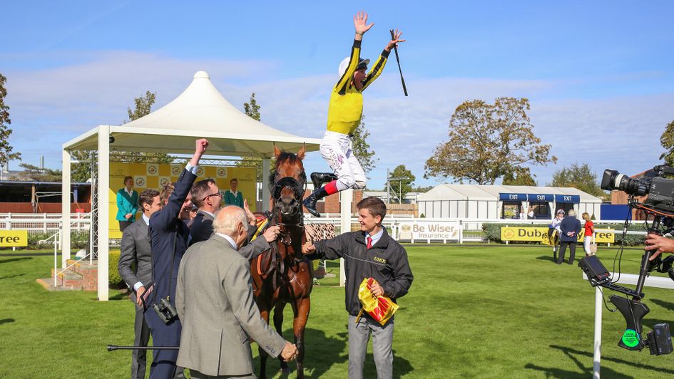 Frankie Dettori leaps from James Garfield after winning the Mill Reef Stakes