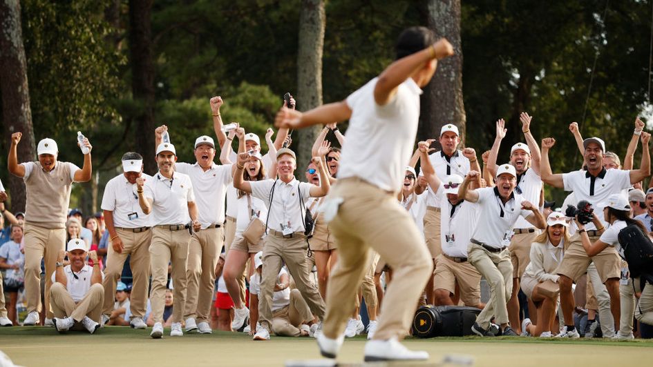 Tom Kim celebrates after collecting a Presidents Cup point