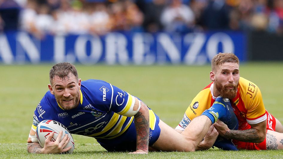Warrington's Daryl Clark is tackled by Catalans Dragons' Sam Tomkins