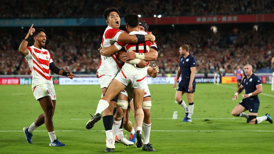 Japan celebrate against Scotland as they win their Rugby World Cup game