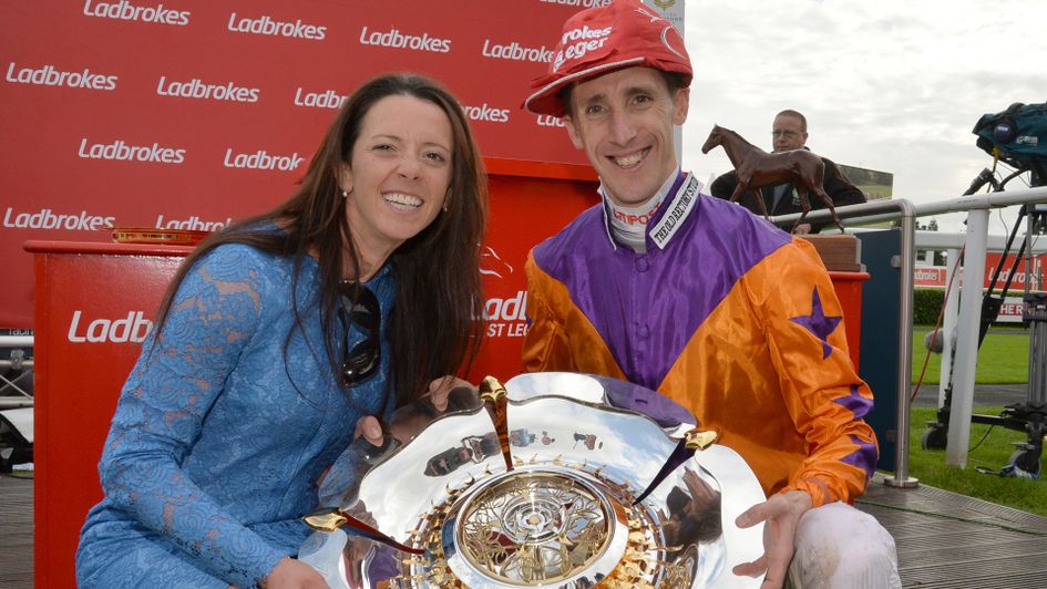 George Baker and Laura Mongan celebrate victory in the St Leger with Harbour Law