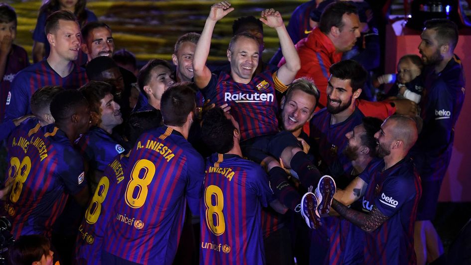 Barcelona players celebrate with Andres Iniesta