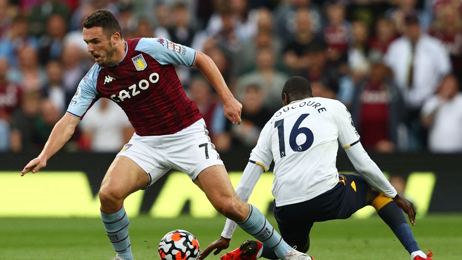 John McGinn (left) dribbles past Abdoulaye Doucoure (right) in Aston Villa v Everton