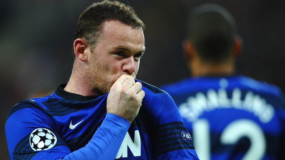 Wayne Rooney kisses the Manchester United badge
