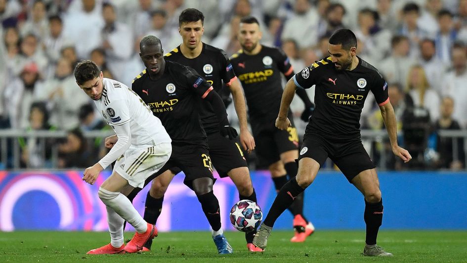 Federico Valverde is surrounded by Manchester City players