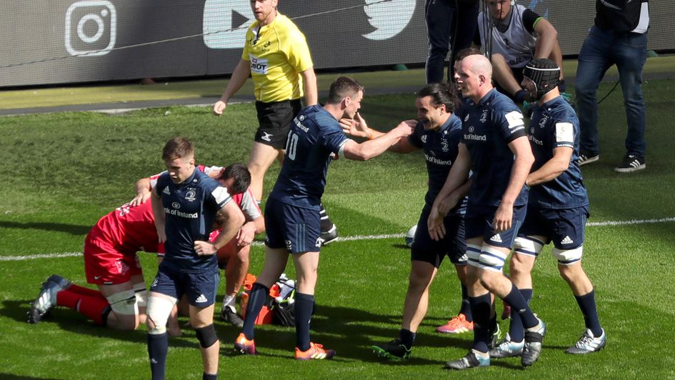 Leinster's James Lowe is congratulated by team-mates after scoring a try