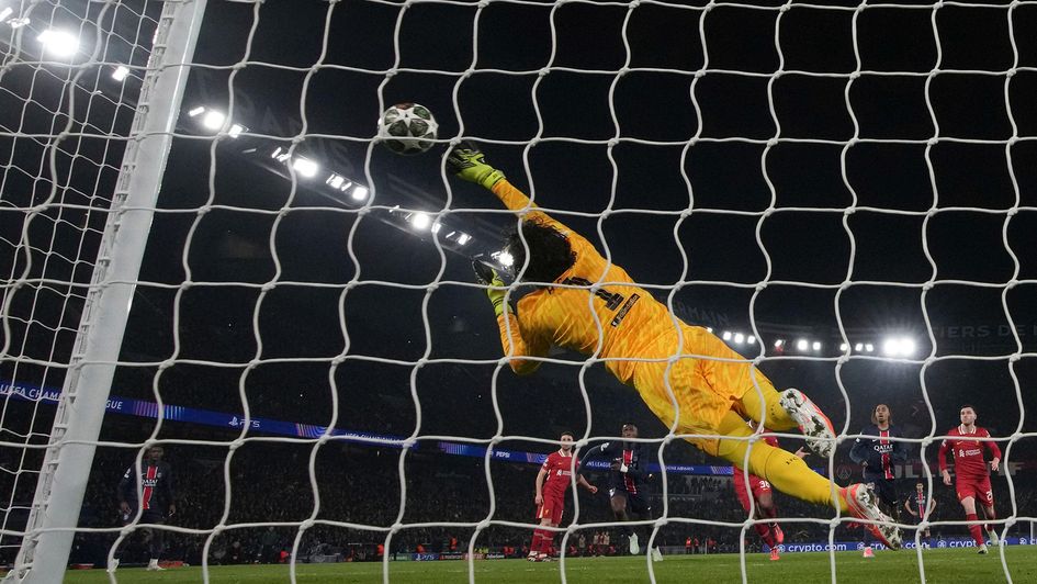 Alisson Becker makes a save against PSG