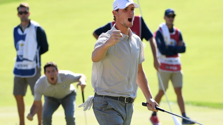 Thomas Pieters celebrates with Rory McIlroy in the background