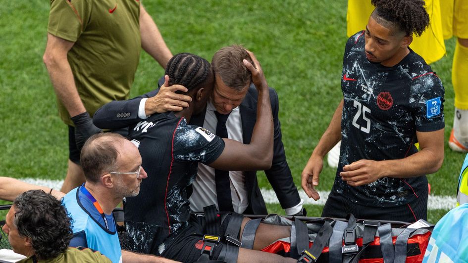 Ismael Kone is consoled by Canada manager Jesse Marsch