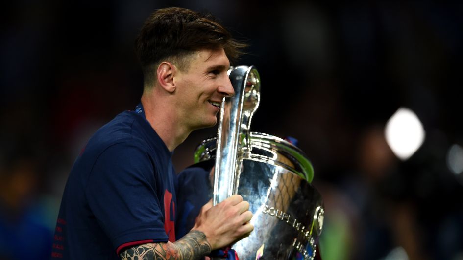 Lionel Messi poses with the Champions league trophy