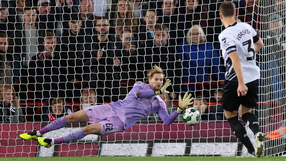 Caoimhin Kelleher saves a penalty from Craig Forsyth