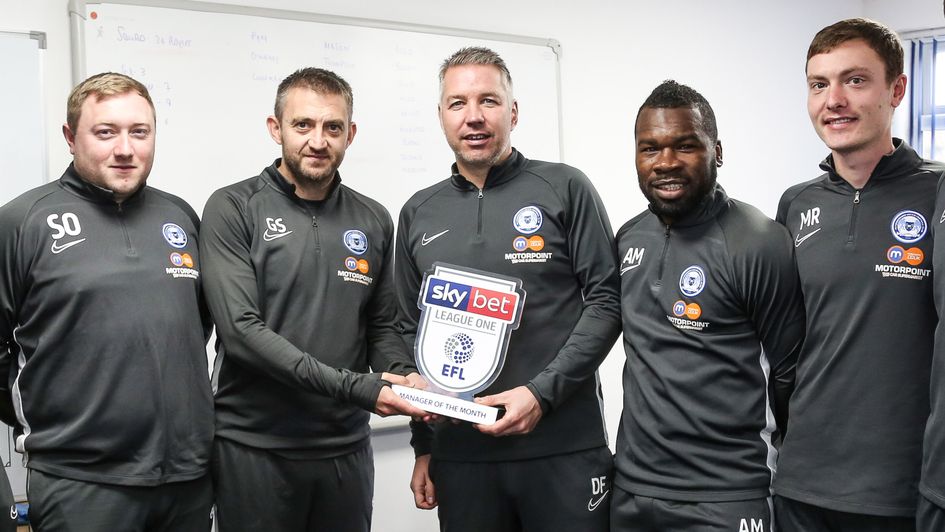 Peterborough staff, pictured with Darren Ferguson's (centre) award for October's Sky Bet League One Manager of the Month