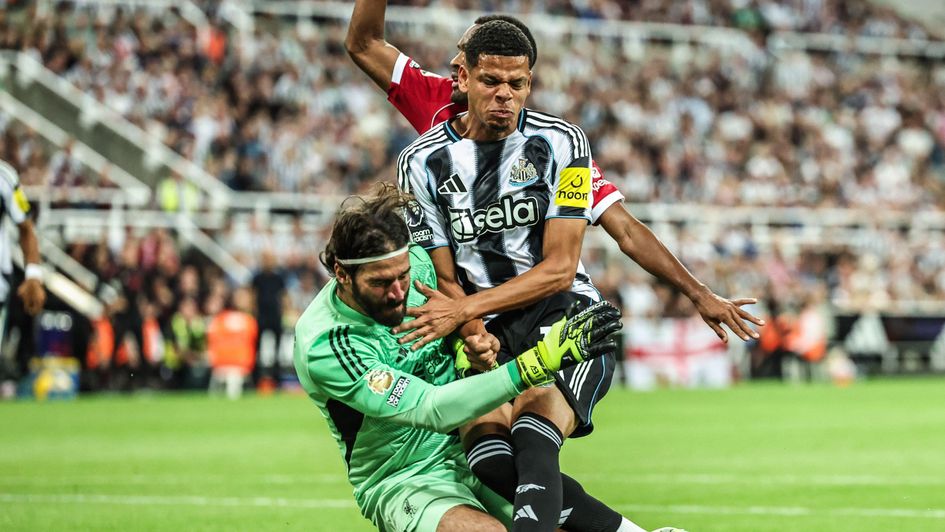 Newcastle's William Osula fouling Alisson