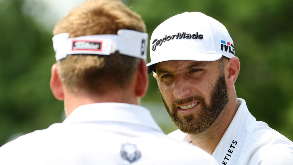 Dustin Johnson chats to Ian Poulter