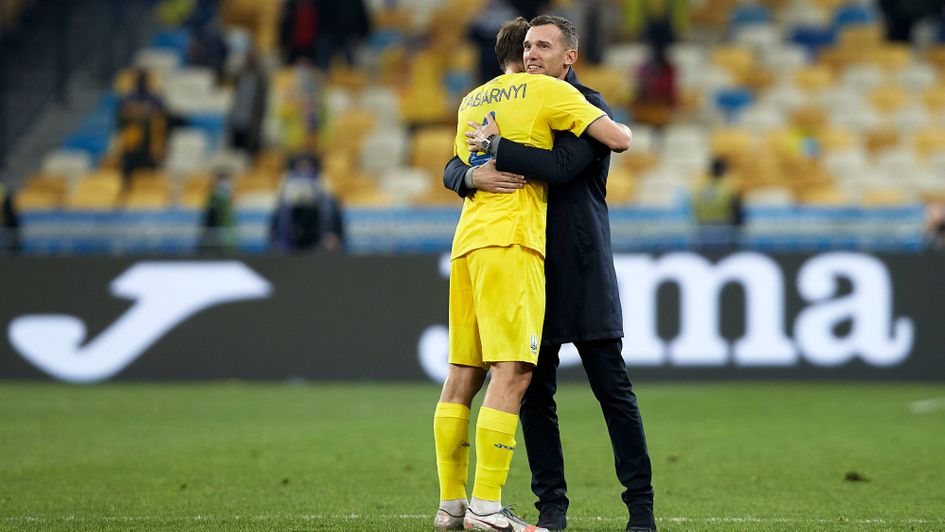 Ukraine manager Andriy Shevchenko embraces Illia Zabarnyl after victory over Spain