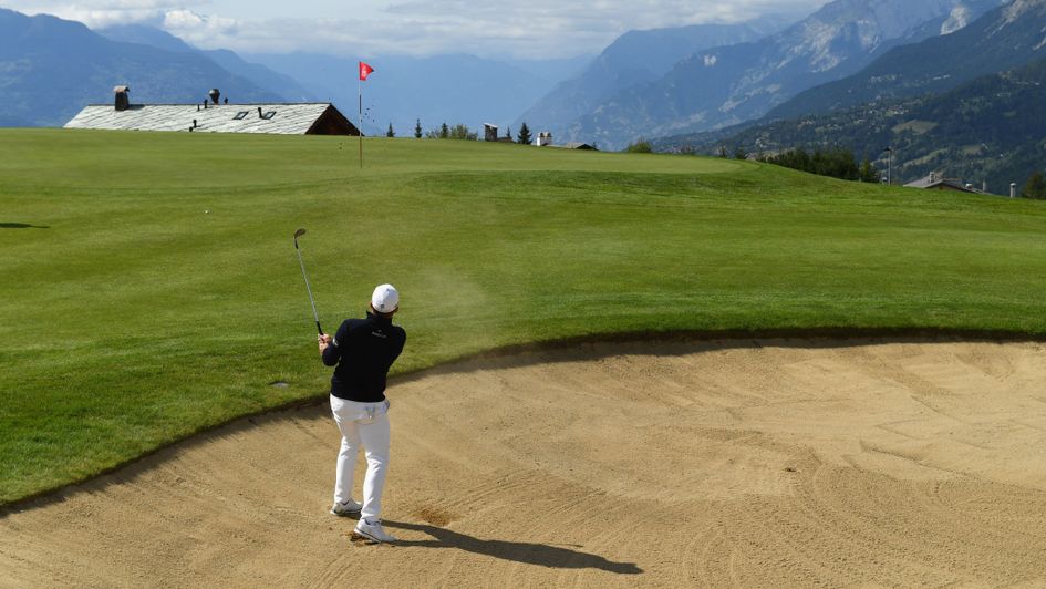 Tyrell Hatton plays a bunker shot - but what a backdrop