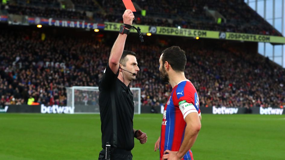 Michael Oliver sends off Luka Milivojevic after using VAR pitchside monitor