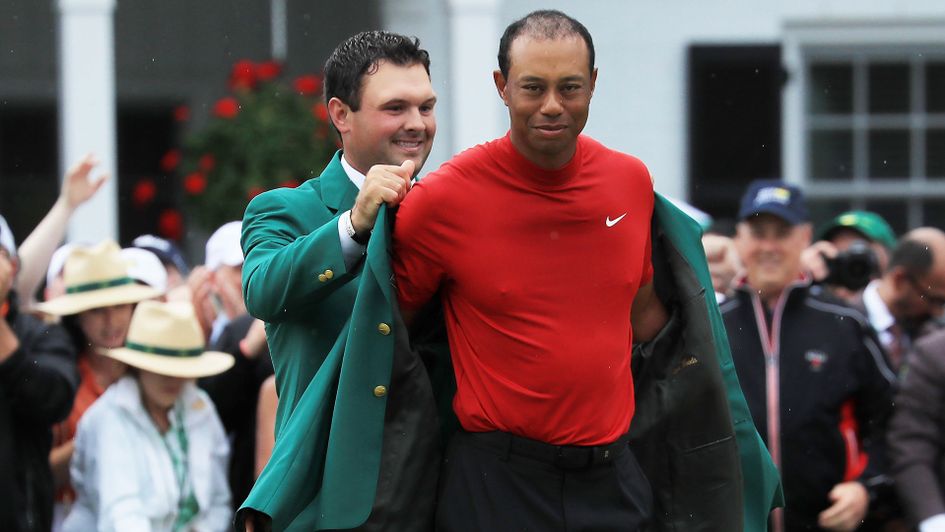 Tiger Woods receives his fifth Masters Green Jacket from 2018 winner Patrick Reed