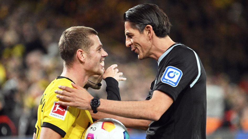 Julian Ryerson is spoken to by the referee