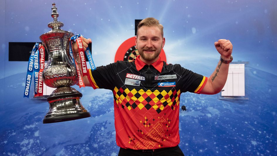 Dimitri Van den Bergh holds the World Matchplay trophy (Picture: Lawrence Lustig/PDC)