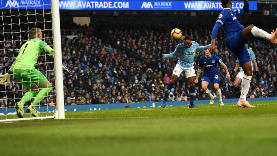Raheem Sterling heads in Manchester City's third against Everton