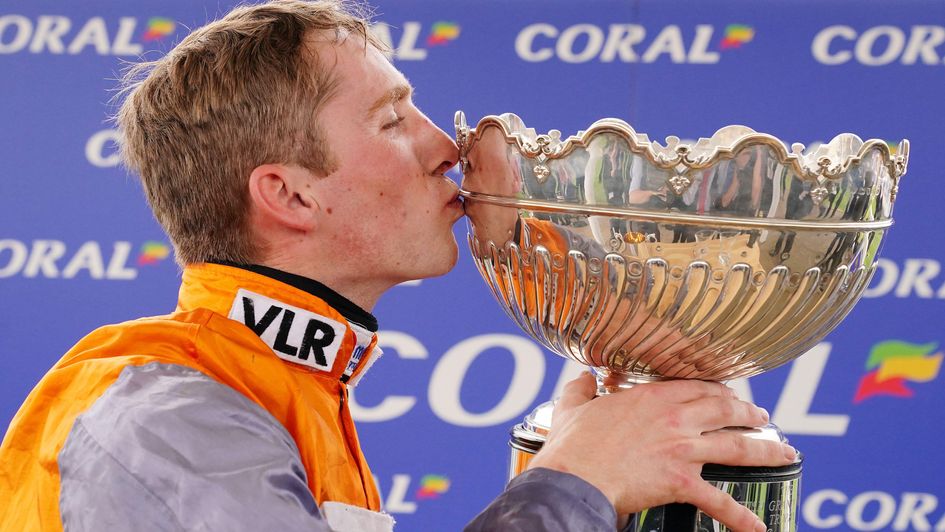 Harry Cobden kisses the trophy