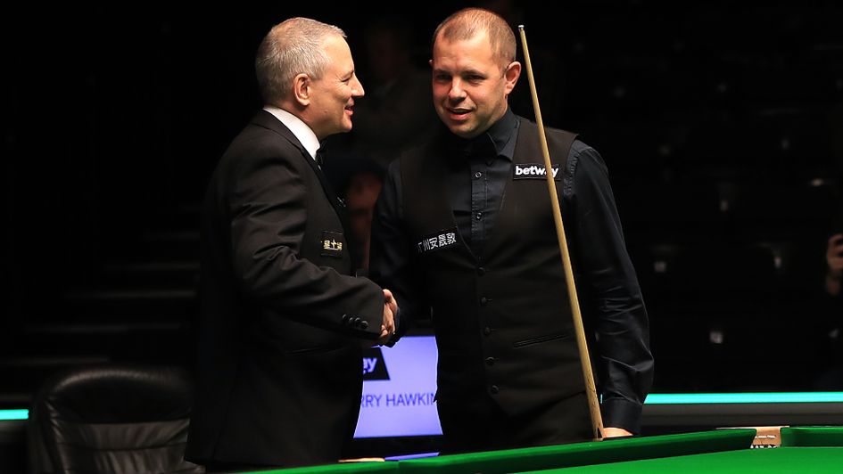 Barry Hawkins is congratulated by referee Brendan Moore