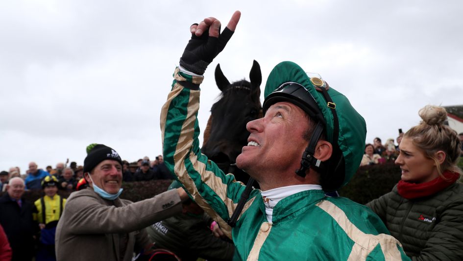 Frankie Dettori points to the sky after winning a Bellewstown race in honour of Barney Curley