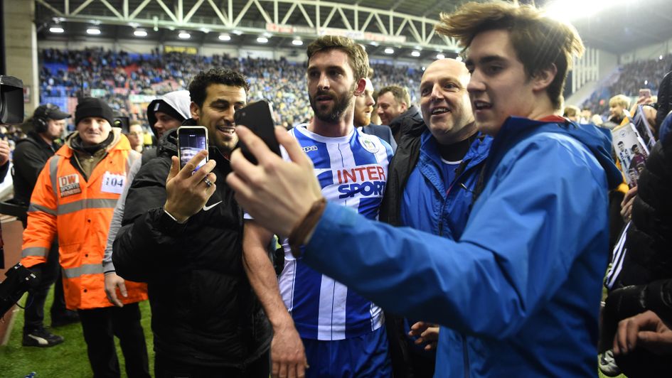 Wigan fans celebrate with Will Grigg