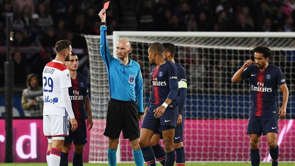 Benoit Bastien shows Lucas Tousart a red card in Lyon's defeat to PSG