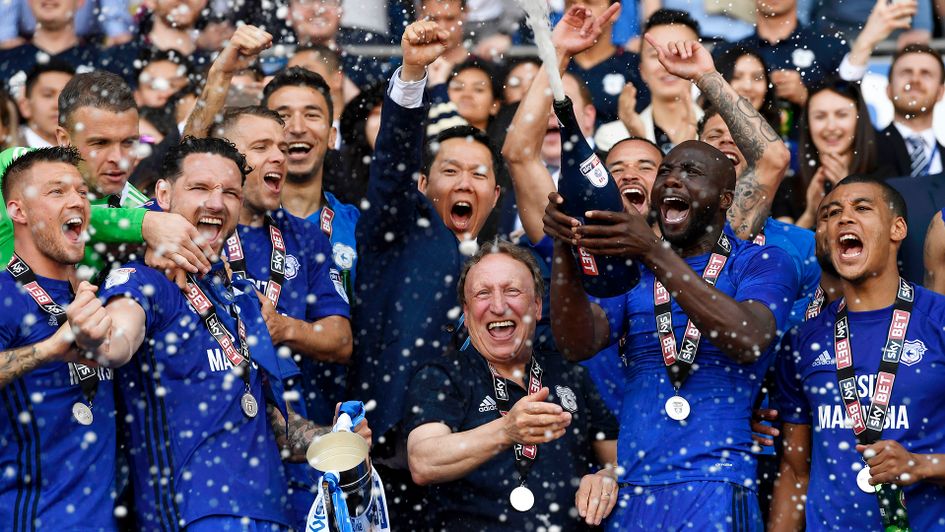 Neil Warnock (centre) celebrates with his players after Cardiff's promotion to the Premier League