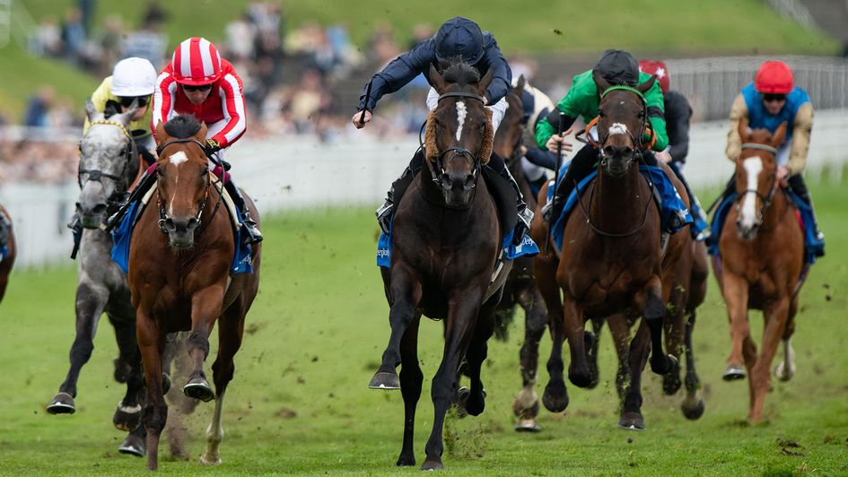Lambourn (centre) wins the Huxley under Ryan Moore