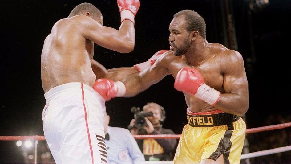 Evander Holyfield delivers a blow to the body of Riddick Bowe