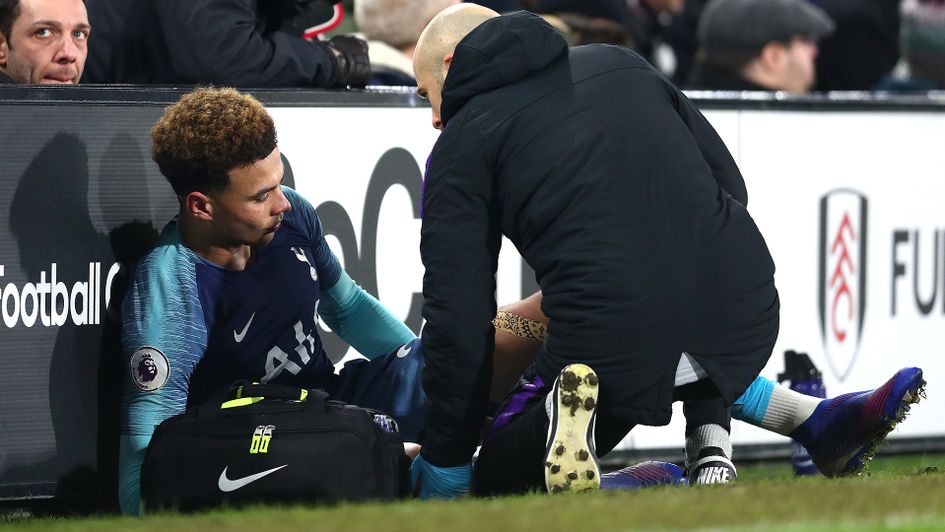 Dele Alli receives treatment on the sidelines at Fulham