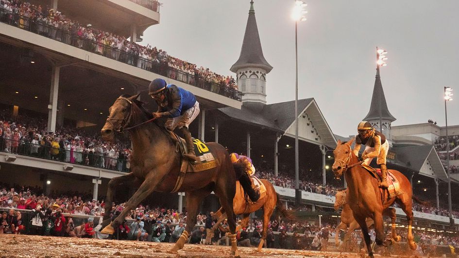 Sovereignty, ridden by Junior Alvarado, left, crosses the finish line to win the 151st running of the Kentucky Derby