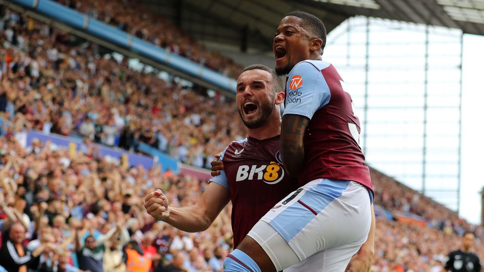 John McGinn celebrates a goal with Leon Bailey