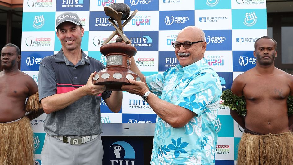 Jason Norris and the President of the Republic of Fiji, George Konrote pose with the trophy after the 2017 Fiji International