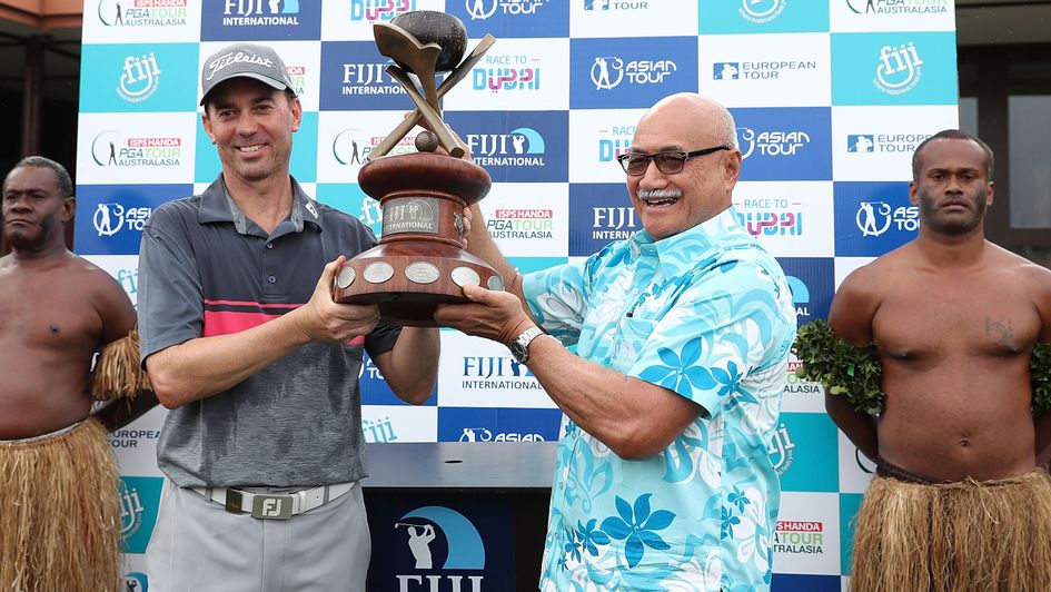 Jason Norris and the President of the Republic of Fiji, George Konrote pose with the trophy after the 2017 Fiji International 