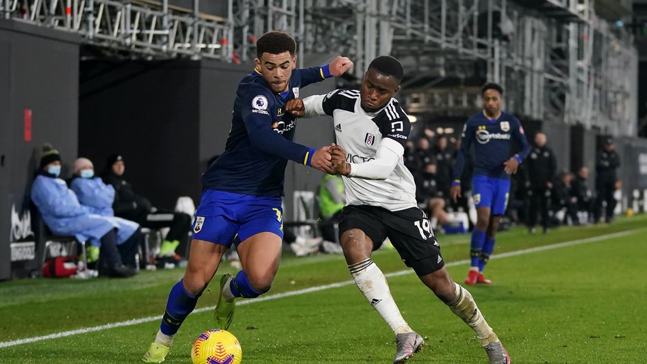 Che Adams and Ademola Lookman battle for the ball