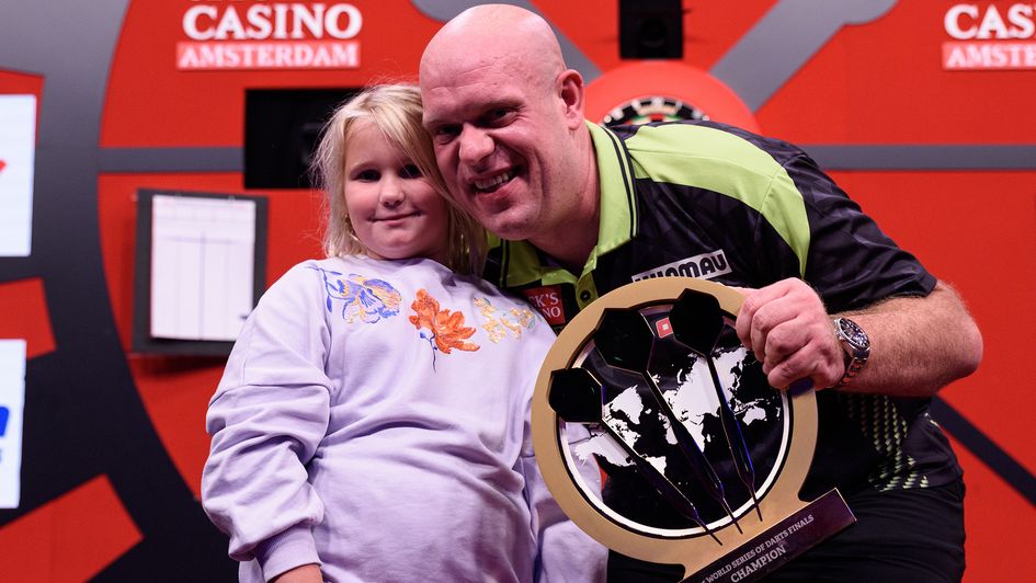 Michael van Gerwen celebrates winning the World Series of Darts Finals with his daughter Zoe