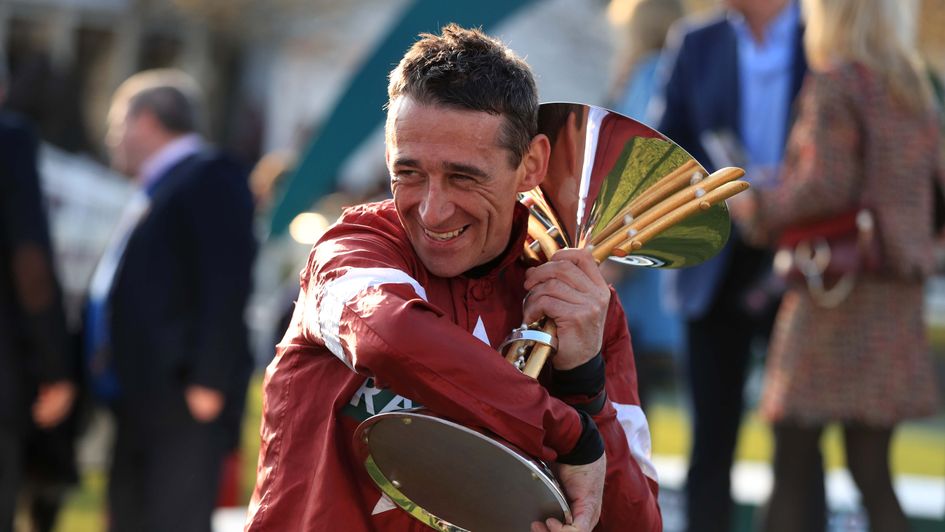 Davy Russell holds on tight to the Grand National trophy
