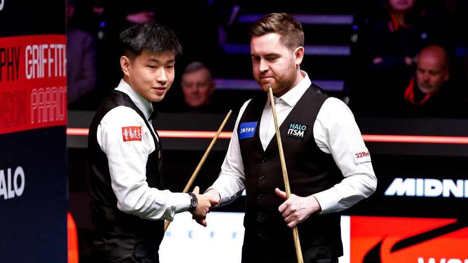 Zhao Xintong shakes hands with Jak Jones at the Crucible