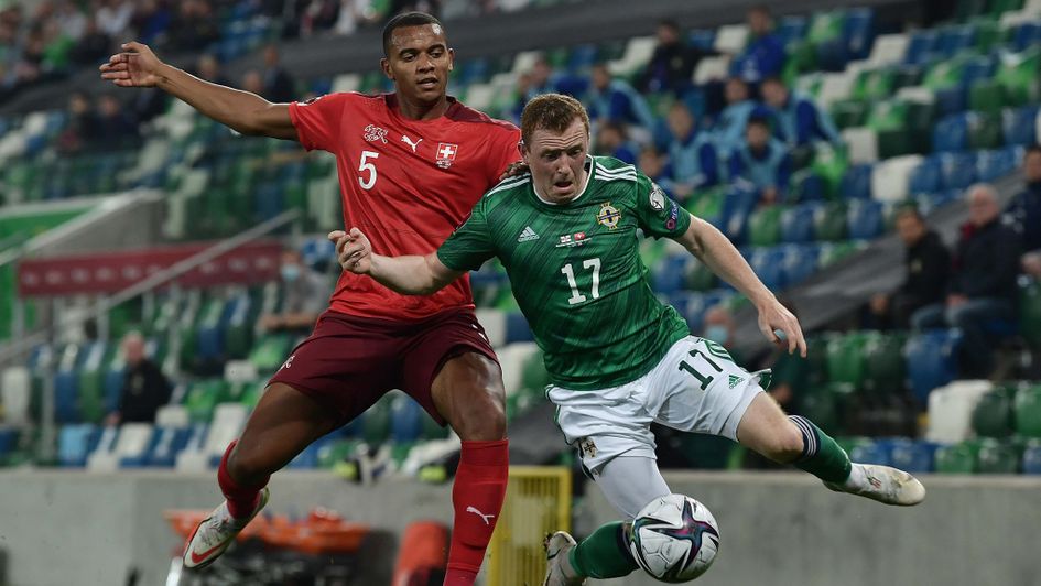 Shayne Lavery of Northern Ireland and Manuel Akanji of Switzerland