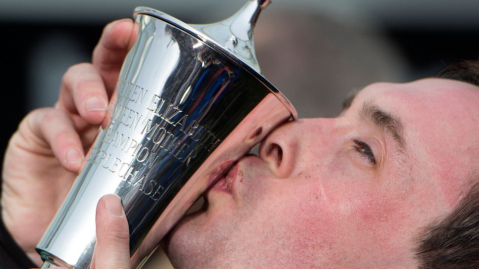 Nico de Boinville kisses the Champion Chase trophy