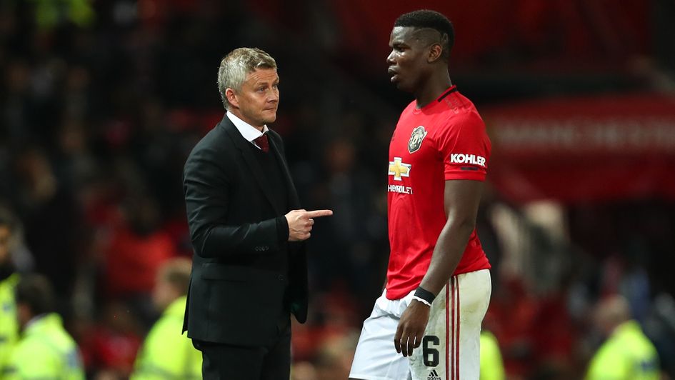 Ole Gunnar Solskjaer in discussion with Paul Pogba
