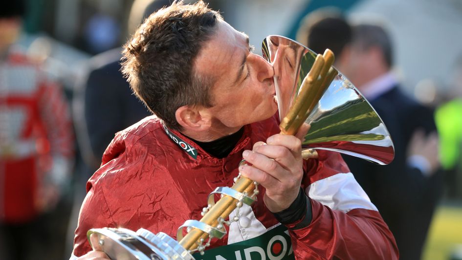 Davy Russell shares a special moment with the Grand National trophy